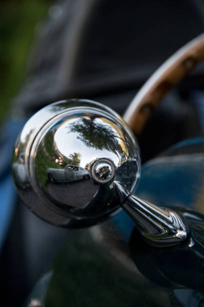 istock chrome side mirror reflection of classic car 1352713177
