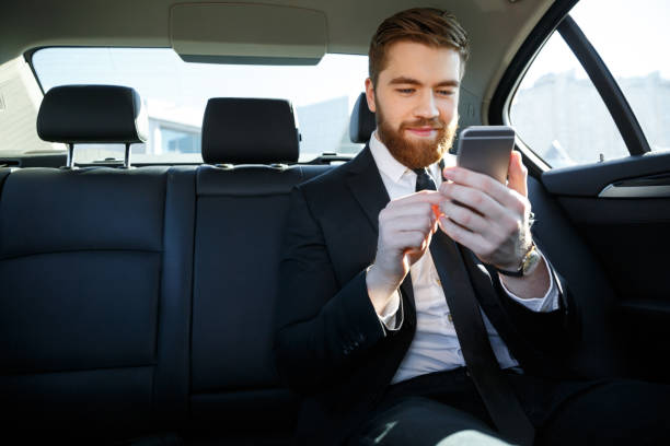 istock Man in suit looking at mobile phone in his hand 1352713235