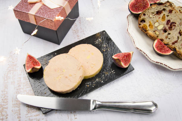 foie gras foie gras on a board with bread on a table foie gras stock pictures, royalty-free photos & images