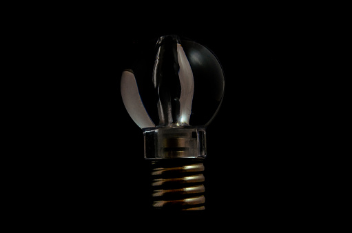 Photo of an Illuminated Light Bulb on Black Background