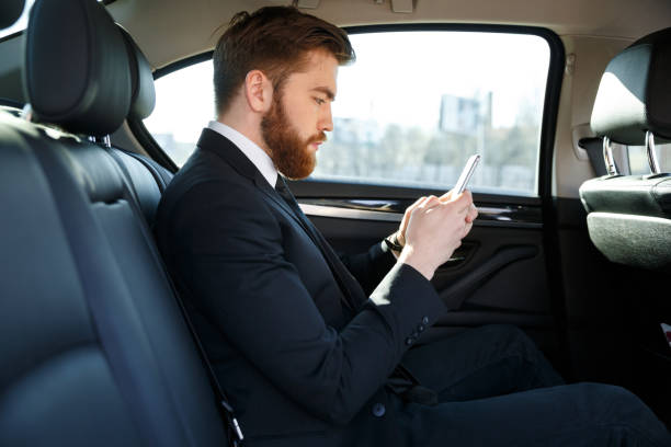 istock Side view of bearded business man using smartphone 1352713978
