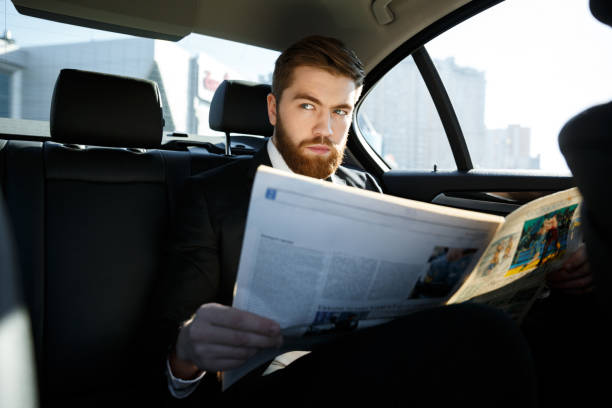 istock Serious business man with newspaper 1352714778