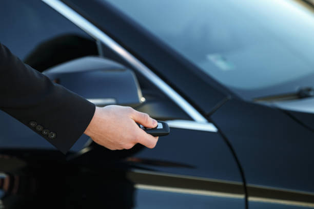 istock Young man opening his car door with the control remote key 1352715134