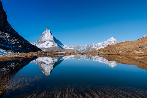 View of the Matterhorn, Swiss Alps, Valais, Switzerland\nmountain lake Riffelsee in the morning light