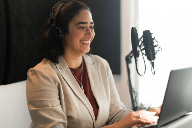istock Woman recording a podcast at home 1352716144