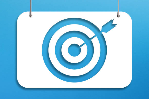 istock Target sign on paper hanging with rope on blue background 1352716224