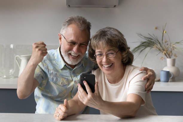 istock Euphoric mature couple celebrating online lottery win. 1352716485