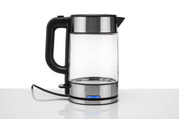 istock Glass, electric, modern transparent kettle on a white background. On the table, with an LED indicator. Close-up 1352716540