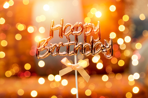 happy birthday text with knot and bokeh light, morocco lounge background