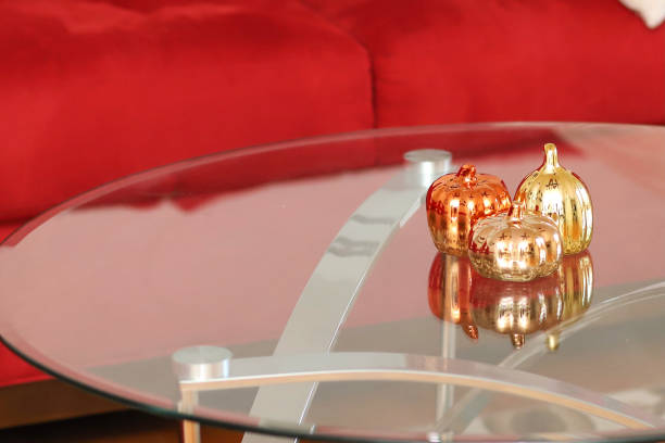 istock Autumn  pumpkin decorations on a glass coffee table 1352718798