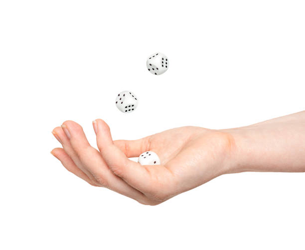istock dices in hand and in air isolated on white background. levitation 1352720444