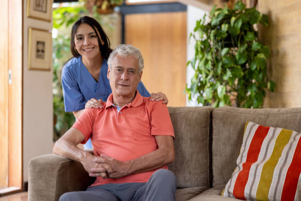 istock Senior man at home with his home caregiver 1352721191