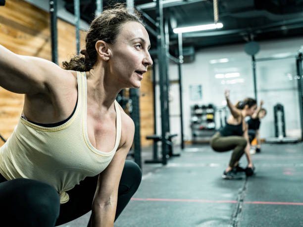 istock Women lifting weights in the Gym 1352722640