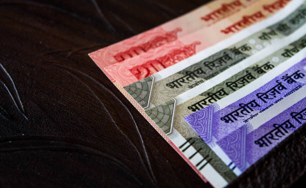 istock Indian currency in wallet isolated on a dark background 1352722837