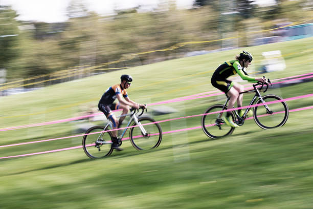 Two men compete in a cyclo-cross race in Calgary, Alberta, Canada. Cyclo-Cross bikes are similar to road bikes but have larger tires with tread for riding on rough terrain. Cyclo-Cross races usually happen in an urban setting where riders do multiple laps of the same course. (John Gibson Photo/GibsonPictures)