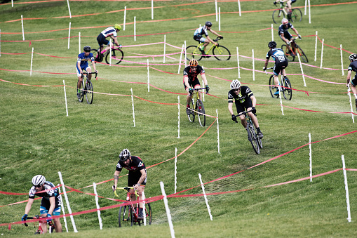 A group of men compete in a cyclo-cross race in Calgary, Alberta, Canada. Cyclo-Cross bikes are similar to road bikes but have larger tires with tread for riding on rough terrain. Cyclo-Cross races usually happen in an urban setting where riders do multiple laps of the same course. (John Gibson Photo/GibsonPictures)