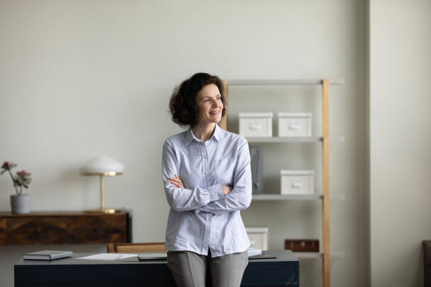 istock Happy dreamy older woman visualizing future at home office. 1352722985