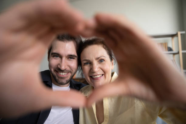 istock Happy two generations family chowing heart symbol. 1352723006