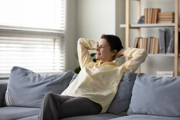 istock Happy peaceful middle aged retired woman relaxing on cozy sofa. 1352723008
