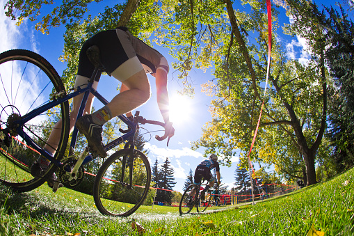 Two men compete in a cyclo-cross race in Calgary, Alberta, Canada. Cyclo-Cross bikes are similar to road bikes but have larger tires with tread for riding on rough terrain. Cyclo-Cross races usually happen in an urban setting where riders do multiple laps of the same course. (John Gibson Photo/GibsonPictures)