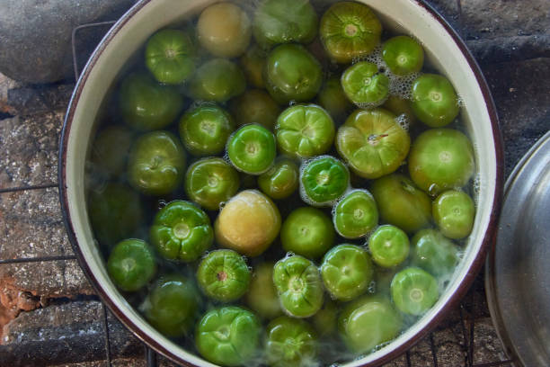 istock Green tomatoes in saucepan filled with boiling water 1352724192