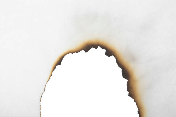 istock Burnt white paper close-up. Burnt paper texture. 1352725556