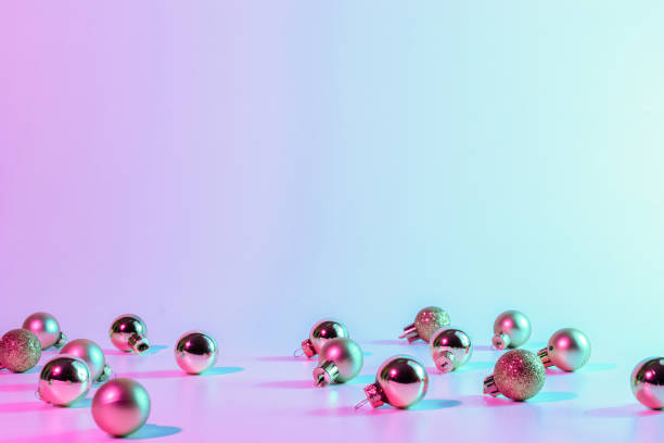 istock Christmas balls pattern neon background. Xmas bauble on abstract holiday winter gradient backdrop. Happy new year copy space. 1352725778