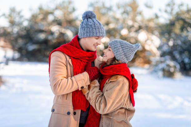 istock Romantic young caucasian couple having fun at winter forest 1352728205
