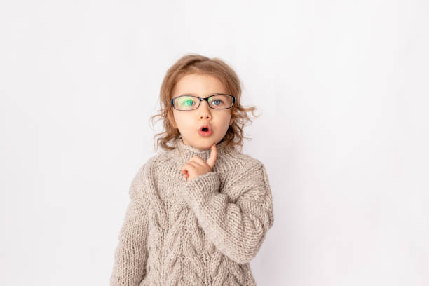 istock surprised child girl with glasses on white background, space for text 1352728421