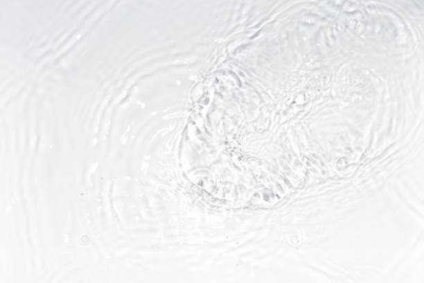 istock White, transparent and clear water surface with splashes and little bubbles. Water texture. Close up view. Trendy abstract nature background. 1352729513