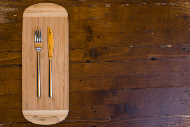 istock Knife and fork on a wooden table 1352732706