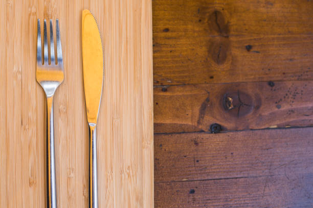 istock Knife and fork on a wooden table 1352732776