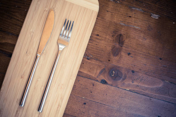 istock Knife and fork on a wooden table 1352732856