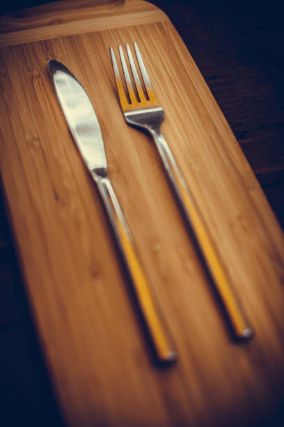 istock Knife and fork on a wooden table 1352732878