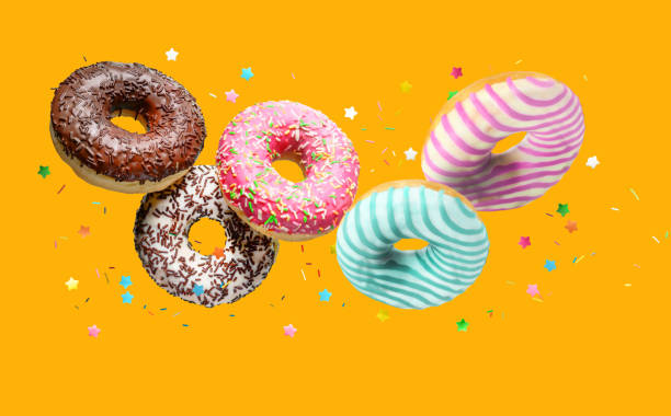 istock Delicious glazed donuts Falling on orange background. 1352732888