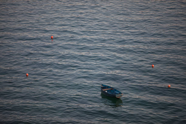 istock Empty wooden boat floating on water 1352733098