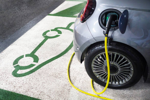 Electric car charging at charging station stock photo