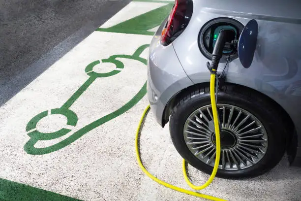 Photo of Electric car charging at charging station