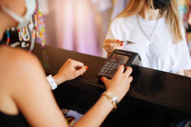 istock Woman purchasing clothes with credit card 1352738009