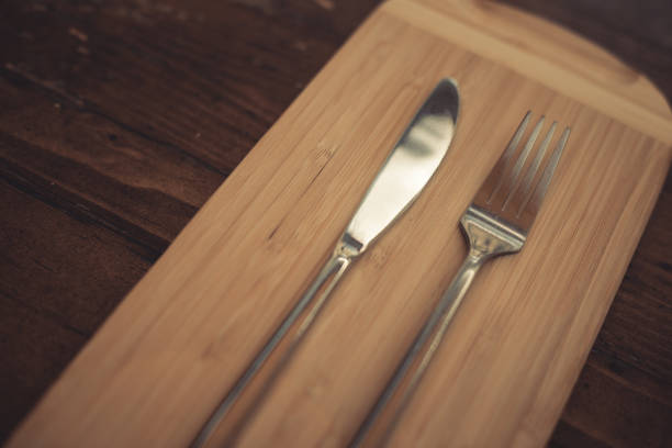istock Knife and fork on a wooden table 1352738612