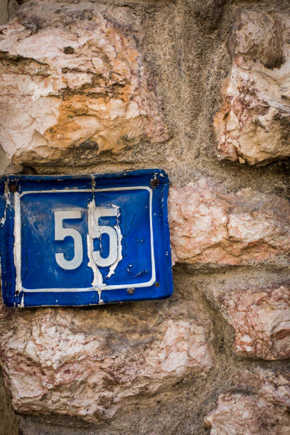 istock Number 55 plaque on a house wall 1352738962