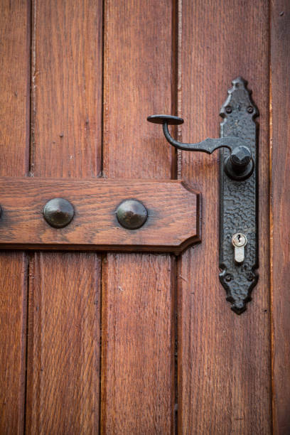 istock Iron decorated door handle on a wooden door 1352739017