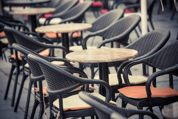 istock Empty chairs and tables at an open air terrace 1352739157