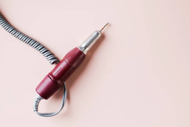 istock Fraser for hardware manicure and pedicure on a pink background. Specialized equipment for nail service masters. 1352740520