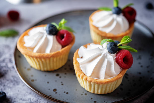istock Sweet tartlets with cream and berries 1352743416