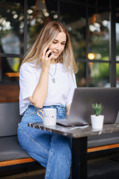 istock Beautiful girl with smart phone in cafe 1352745207