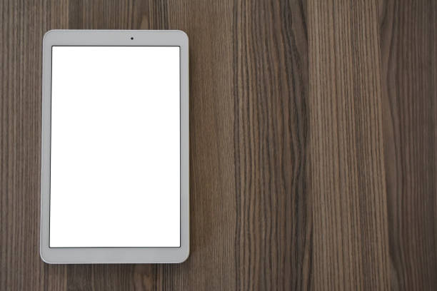 istock Digital tablet (Clipping Path) on the wood table 1352745984