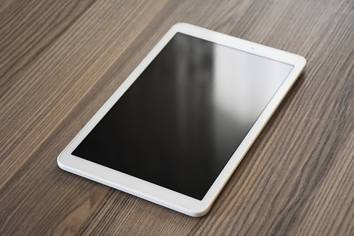 Digital tablet on the wooden table, desk