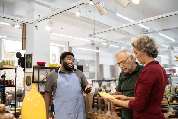 istock Salesman helping a couple at a decoration store 1352746574