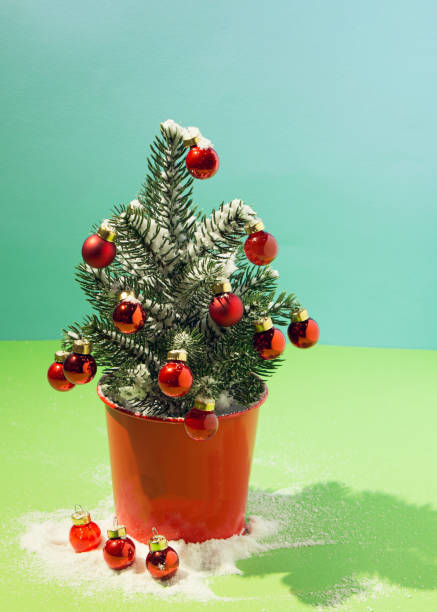istock Christmas tree with snow with decorations on a blue and green background 1352747585